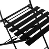 A close-up view of a black metal bistro chair and table set, showing the slatted design and folding mechanism. Produktbild-Vorschau