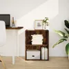 A wooden bookshelf with books and a storage box on a wooden floor, next to a desk with a laptop. Produktbild-Vorschau