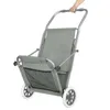 A person's hand is holding the handle of a gray beach chair with wheels. Anteprima dell’immagine prodotto