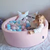 A young child is playing in a pink ball pit with several plush star pillows. Anteprima dell’immagine prodotto