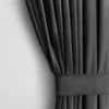 A close-up view of a dark gray curtain with pleats and a fabric band. Produktbild-Vorschau