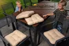 Two children are sitting at a wooden outdoor table with chair cushions. Produktbild-Vorschau