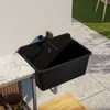 An outdoor sink mounted on a wall next to a countertop, with tiles and grass in the background. Produktbild-Vorschau