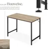 A desk with a wooden top and black metal legs, shown from a slightly elevated angle. Text describes its construction. Produktbild-Vorschau
