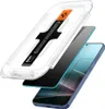 An exploded view of a phone screen protector kit, showing the screen protector, an application guide, and a phone. Náhľad obrázku produktu