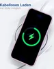 A smartphone in a purple case is placed on a wireless charger, indicating charging. Produktbild-Vorschau