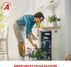 A woman is loading dishes into a dishwasher in a kitchen. Voir les images du produit