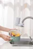 A hand is holding a pot of food under a faucet with a water filter attachment. Náhled obrázku produktu