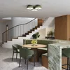 A modern kitchen and dining area with a curved green banquette, a wooden dining table, and a marble countertop. Produktbild-Vorschau