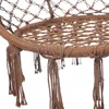 A close-up view of the bottom part of a brown macrame hanging chair, showing the woven seat and tassels. Produktbild-Vorschau