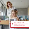 A mother is drying her daughter's hair with a hairdryer in a bathroom. Anteprima dell’immagine prodotto