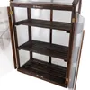 A dark brown wooden mini greenhouse with clear polycarbonate panels and shelves, shown with its doors open. Voir les images du produit