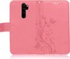 A pink flip case for a smartphone, with a floral and butterfly embossed pattern. Produktbild-Vorschau