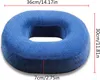 A blue donut-shaped cushion with dimensions indicated by red lines and text. Produktbild-Vorschau