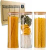 Three glass jars filled with different types of pasta, with a cardboard box in the background. Voir les images du produit
