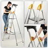 A collage of images showing a woman using an aluminum ladder with yellow handrails and a black platform. Náhled obrázku produktu