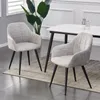 Two dining chairs are placed on a rug in front of a dining table. Voir les images du produit