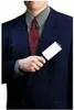 A person in a suit is holding a lint roller. Anteprima dell’immagine prodotto
