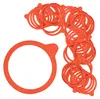 A pile of orange rubber sealing rings for canning jars, with one large ring in the foreground. Produktbild-Vorschau