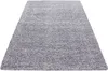 A light gray, high-pile shaggy rug is shown from a diagonal angle against a white background. Podgląd zdjęcia produktu