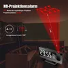 A digital alarm clock projecting a red light onto a ceiling in a dimly lit room, with a sofa in the background. Náhled obrázku produktu