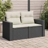 A two-seater outdoor sofa with beige cushions sits on a paved patio, with greenery and a wooden fence in the background. Produktbild-Vorschau