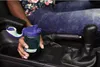 A person's hand is holding a Nalgene water bottle in the cup holder of a car. Náhľad obrázku produktu