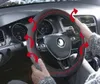 Hands holding a steering wheel cover inside a car. Podgląd zdjęcia produktu