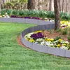 A curved garden border made of gray plastic blocks separates a lawn from a flower bed with colorful flowers. Náhled obrázku produktu