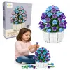 A young girl is sitting on the floor building a flower bouquet from toy blocks, with the product packaging and a finished bouquet in the background. Náhľad obrázku produktu