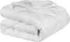 A white comforter is folded and lying on a white surface. Produktbild-Vorschau