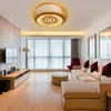 A modern living room with a large window, sofa, TV, and a unique ceiling lamp. Náhled obrázku produktu