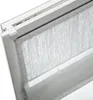 A close-up view of a white roller blind with a textured fabric, installed in a window frame. Produktbild-Vorschau
