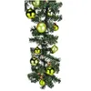 A close-up shot of a green Christmas garland decorated with lime green baubles. Voir les images du produit
