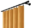 A set of yellow curtains hanging from a black curtain rod. Náhled obrázku produktu