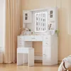 A white vanity table with a lighted mirror and a stool, set in a room with beige curtains. Produktbild-Vorschau