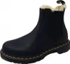 A black Dr. Martens boot with a cream-colored fuzzy lining is shown against a white background. Produktbild-Vorschau