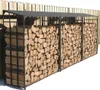 A long, black metal firewood rack filled with chopped wood, positioned against a wooden fence. Podgląd zdjęcia produktu