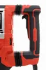A close-up view of the handle and trigger mechanism of a red and black power tool, likely a hammer drill. Náhled obrázku produktu