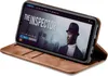 A smartphone in a brown flip case is displayed at an angle, showing a movie poster on its screen. Produktbild-Vorschau