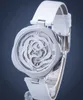 A product shot of a watch on a stand against a dark background. Náhled obrázku produktu