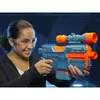 A young girl wearing safety glasses is holding a Nerf Elite 2.0 Phoenix CS-6 blaster. Podgląd zdjęcia produktu