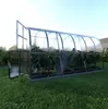 A greenhouse with plants inside, set up on a lawn. Anteprima dell’immagine prodotto