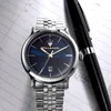 A close-up shot of a Maserati watch with a blue dial, placed on a planner or notebook next to a black pen. Anteprima dell’immagine prodotto