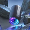 A portable Bluetooth speaker is displayed in a surreal, rocky environment with glowing blue crystals. Produktbild-Vorschau