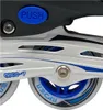 A close-up view of inline skates, focusing on the wheels and a 'push' button. Voir les images du produit