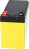 A close-up, angled view of a yellow battery with a black top and red and black terminals. Podgląd zdjęcia produktu