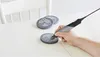 A person is using a Dremel Stylo+ to engrave a circular object on a wooden table. Anteprima dell’immagine prodotto