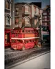 A miniature model of a London double-decker bus and buildings, set on a miniature train track. Náhľad obrázku produktu