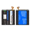 Two batteries are shown against a black honeycomb patterned background. The battery on the left has text and a QR code. The battery on the right has a blue label with text and a German flag. Produktbild-Vorschau